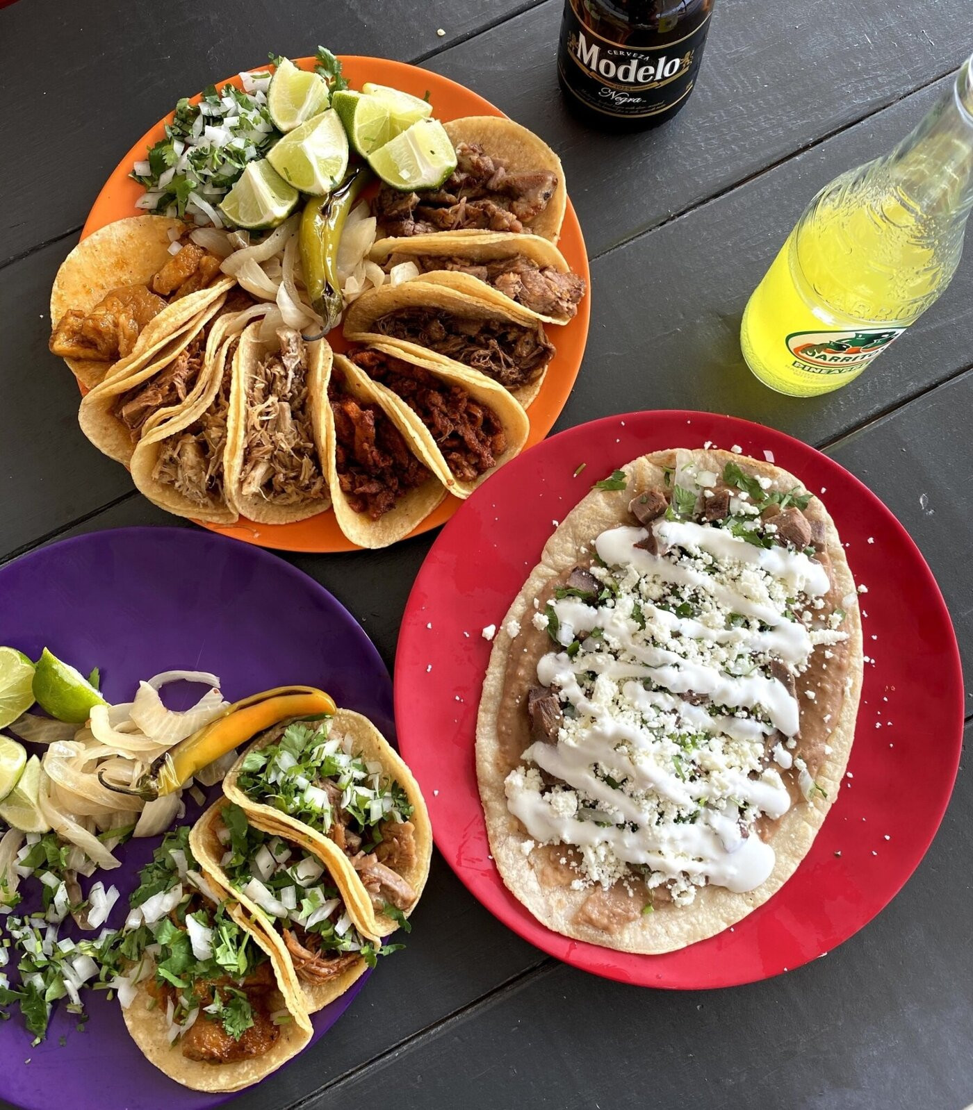 Colorful spread of tacos and huarache from Los Taco H's, Fort Worth TX — corn tortillas, vibrant toppings, Modelo and Jarritos