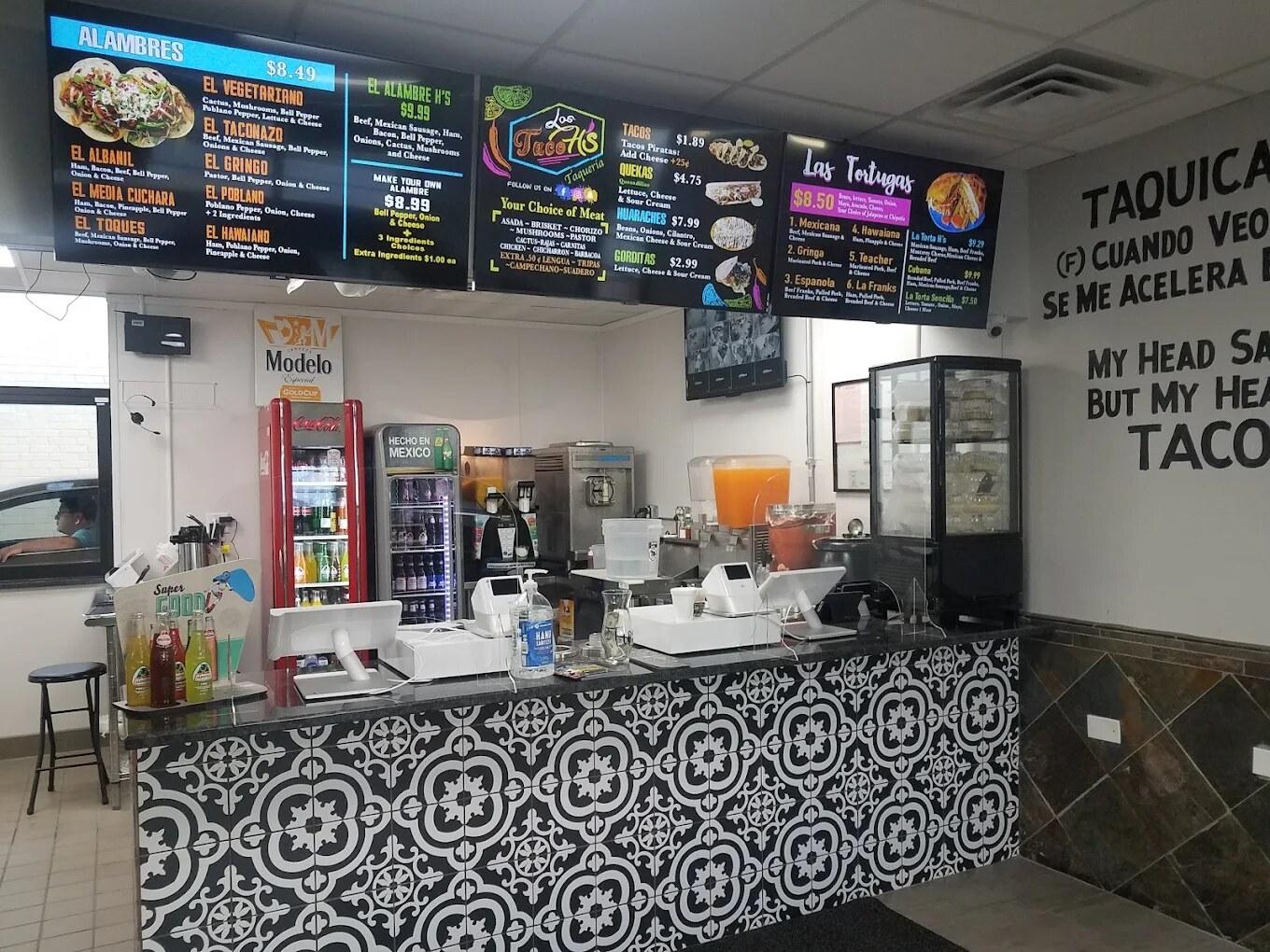 Interior of Los Taco H's — counter service with menu boards and black and white tile floor
